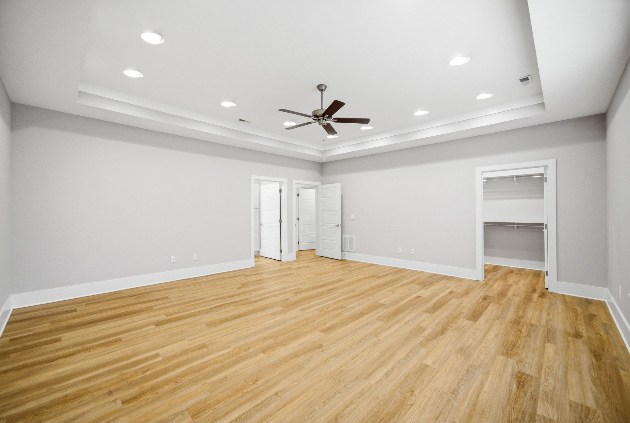 Spacious primary suite with convenient access to the private bath and walk-in closet.