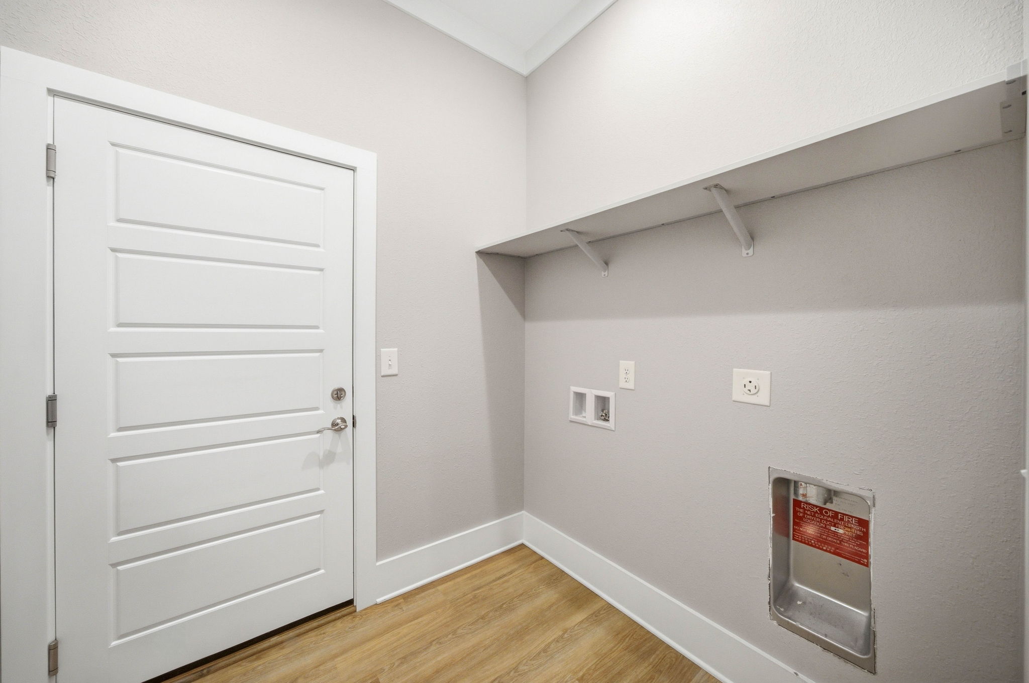 Separate laundry room with washer and dryer hookups and additional utility space.