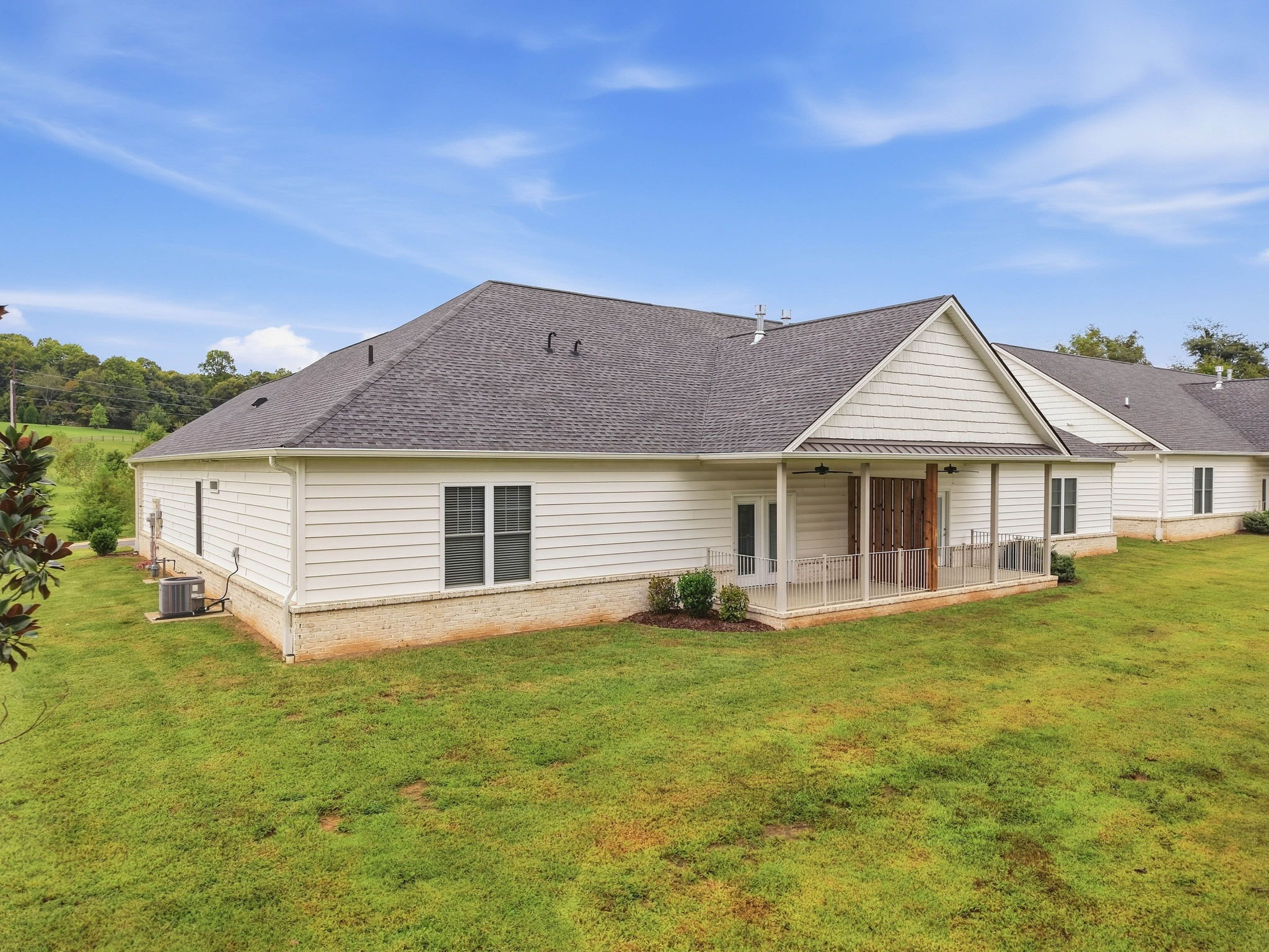 Covered rear patio provides private outdoor living space without the upkeep of a traditional home.